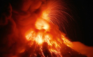 Mayon volcano erupts for the second straight day Tuesday, Jan. 23, 2018 as seen from Legazpi city, Albay province, southeast of Manila, Philippines. The Philippines' most active volcano ejected a huge column of lava fragments, ash and smoke in another thunderous explosion at dawn Tuesday, sending thousands of villagers back to evacuation centers and prompting a warning that a violent eruption may be imminent.