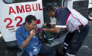 Un ambulancier vient en aide à un passant à Mexico, après qu'un tremblement de terre a frappé la région d'Acapulco, le 20 mars 2012. La réplique a été ressentie jusque dans la capitale.