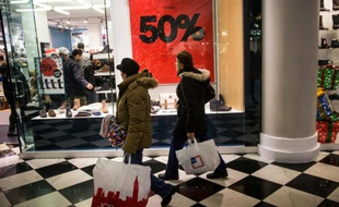 Des passants devant la vitrine d'une boutique de New York lors du "Black Friday", le 28 novembre 2014