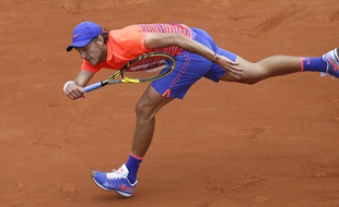 France's Lucas Pouille returns the ball to France's Gilles Simon during the men's first round at the Roland Garros 2015 French Tennis Open in Paris on May 25, 2015. AFP PHOTO / PATRICK KOVARIK