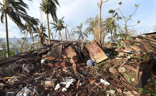 Enfant jouant dans les ruines à Port-Vila, au Vanuatu, après le passage du cyclone Pam, le 16 mars 2015