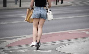 Une femme à trottinette électrique (illustration).